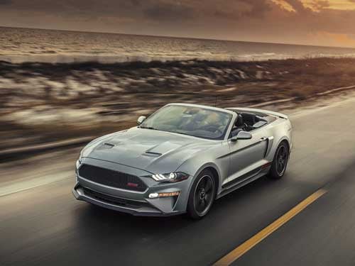 2023 Ford Mustang convertible driving down the road
