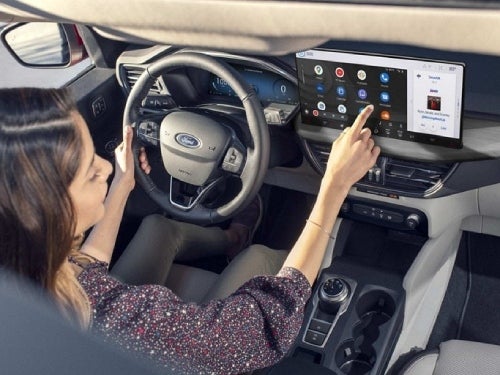 2024 Ford Escape Plug-in Hybrid view of woman using touchscreen
