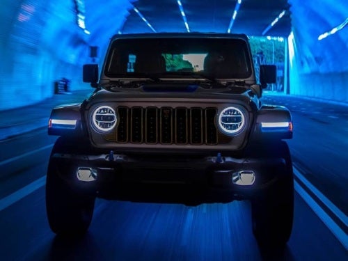 2024 Jeep Wrangler front exterior view driving through a tunnel
