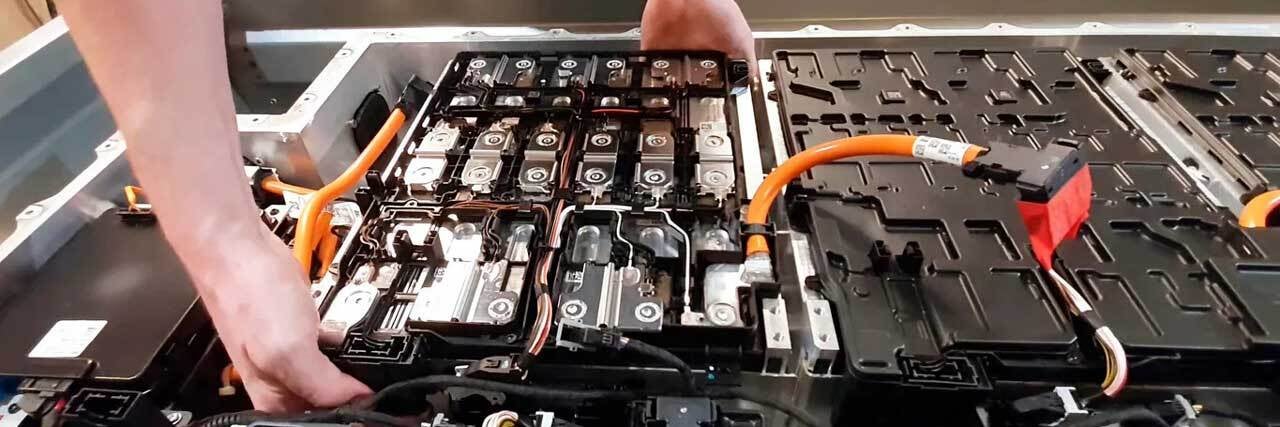 close up view of electric car battery getting serviced