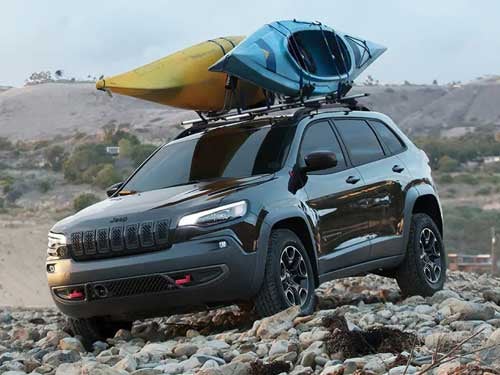 2023 Jeep Cherokee driving on rocky path