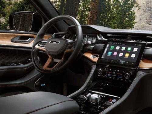 2024 Jeep Grand Cherokee interior view of dash, steering wheel, and front door