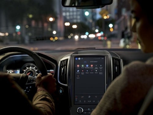 2024 Ford Edge interior view showing couple in front seat driving at night