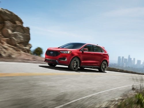 2024 Ford Edge driving around a curve in the road